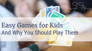 Toddler holding UNO cards with text overlay: Easy Games for Kids and Why You Should Play | Disciple Mama