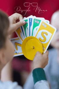 toddler boy holding UNO cards easy games for kids | Disciple Mama