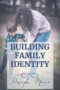 Mother is showing a young boy how to rake leaves; text overlay: Building Family Identity | Disciple Mama